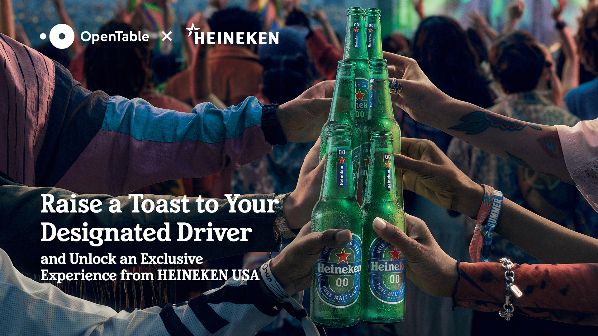 Manos brindando con botellines de Heineken 0.0 bajo los logotipos de OpenTable y Heineken en la campana para premiar al conductor designado