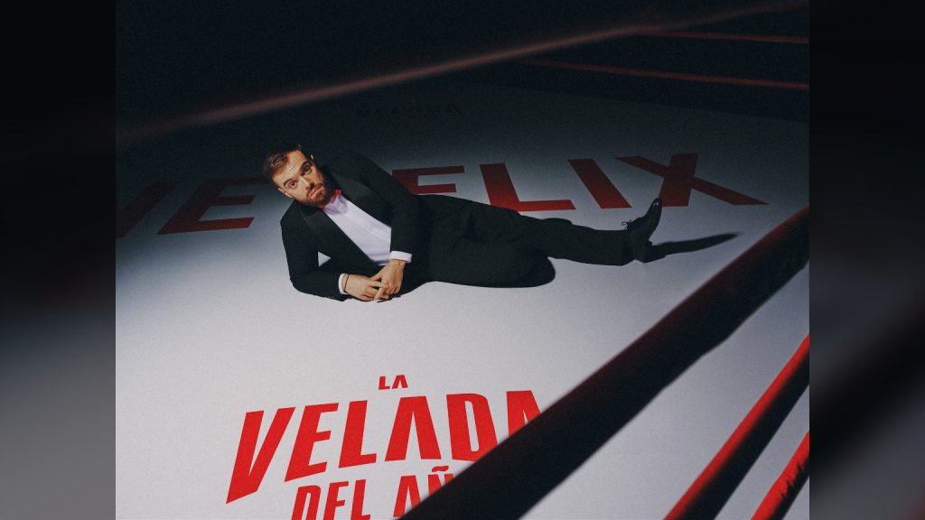Ibai Llanos tumbado en un ring de boxeo con los logos de Netflix y La Velada del Año en la lona, imagen oficial del acuerdo